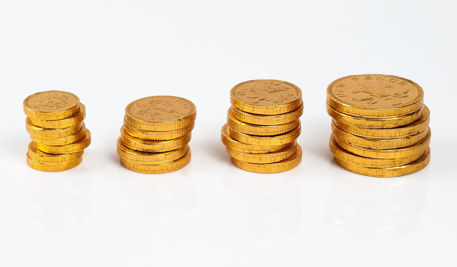 Sample post photo: stacks of gold coins on a white surface.
